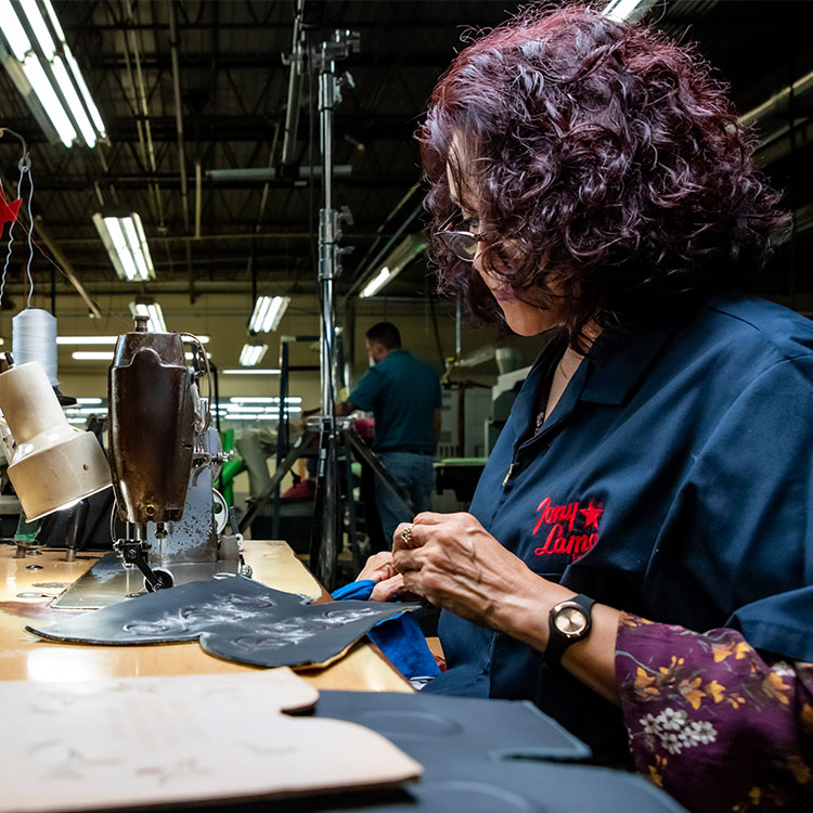 Women sews leather 
